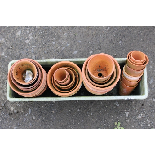 28 - A large assortment of small terracotta pots.