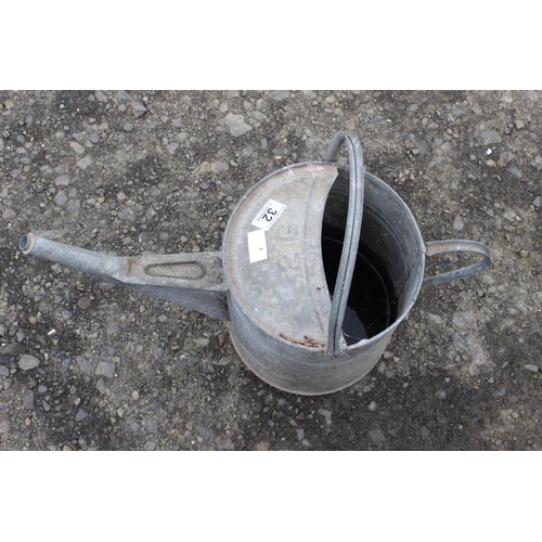 32 - A vintage galvanised watering can.