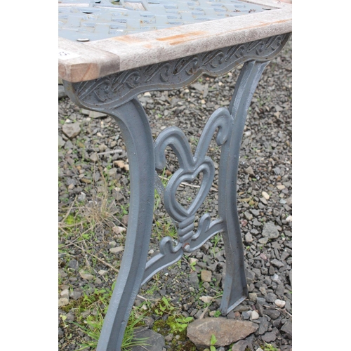 35 - A garden table with cast iron top panel & ends.