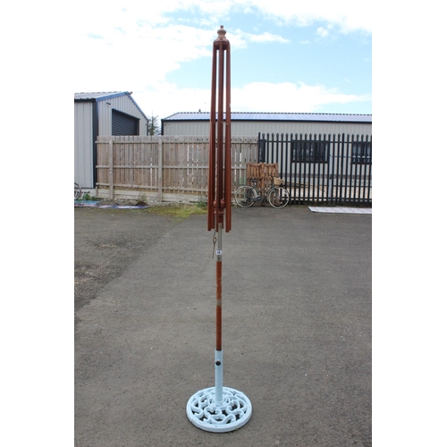 68 - A garden parasol (a/f) on a cast iron base.