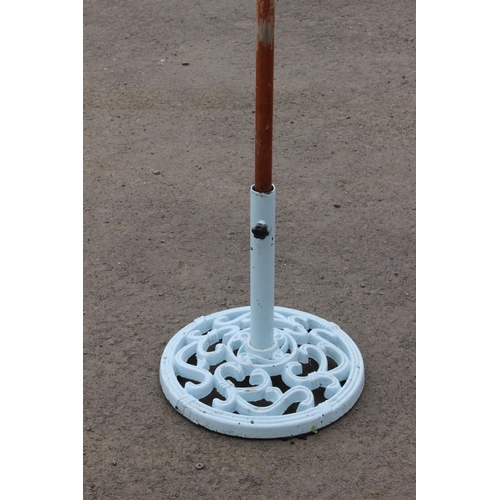 68 - A garden parasol (a/f) on a cast iron base.