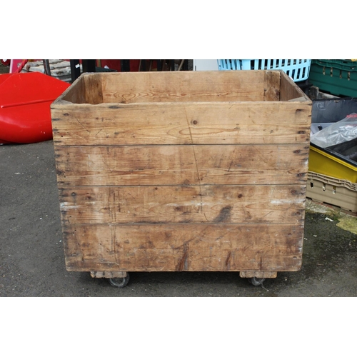 99 - A large antique pine linen crate on casters from Clarkes Linen Mill, measuring 39