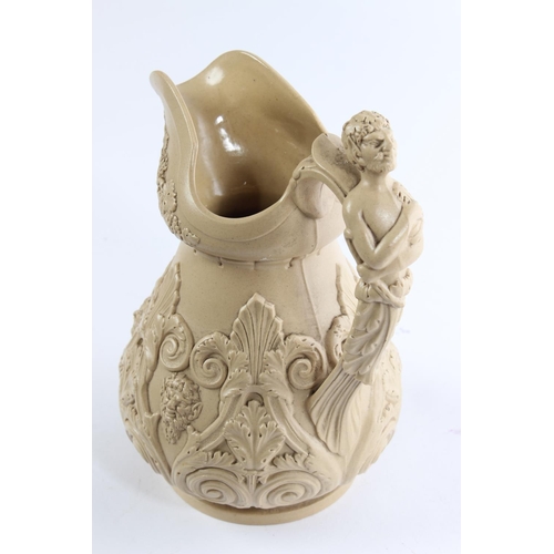 129 - An antique/ Victorian ceramic mask claret jug.