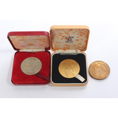 145 - Two cased commemorative coins and another.