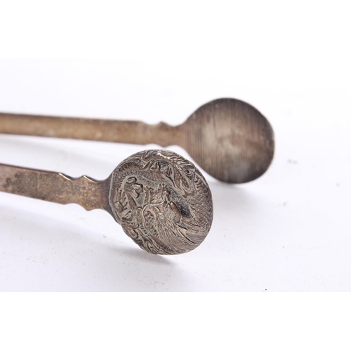 152 - A rare pair of white metal Incense Chinese tongs with dragon design.