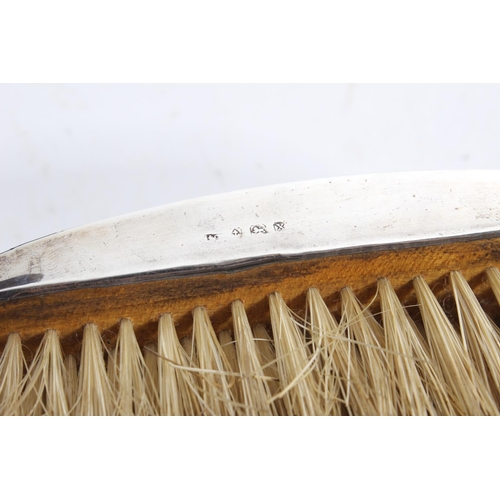 153 - A cased pair of antique silver mounted engraved dressing table brushes.