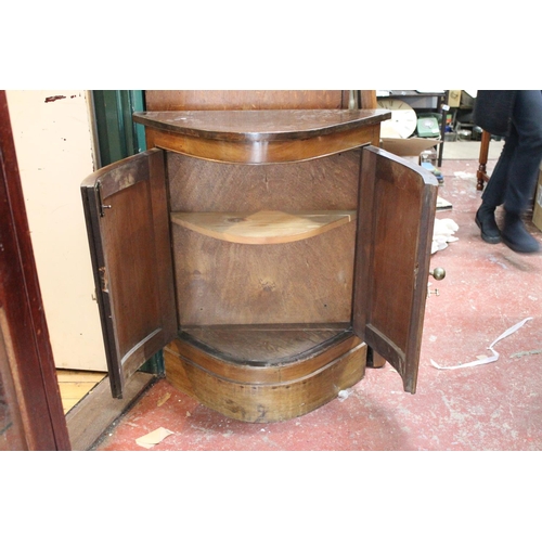 173 - An antique style bow front cabinet.