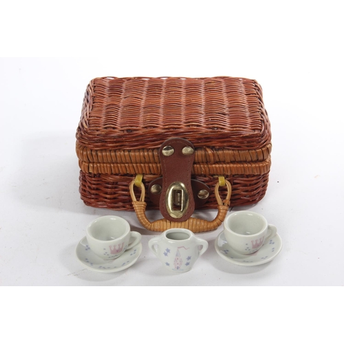 176 - A miniature wicker picnic basket and ceramic tea set.