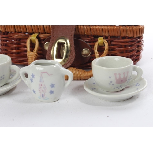 176 - A miniature wicker picnic basket and ceramic tea set.