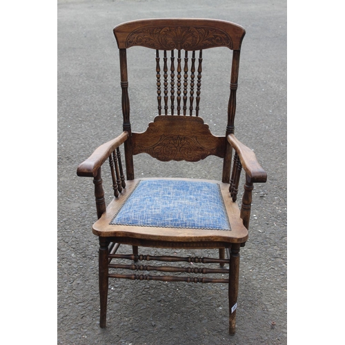 187 - An antique carved oak armchair with upholstered seat.