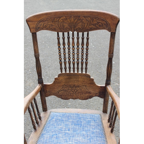 187 - An antique carved oak armchair with upholstered seat.