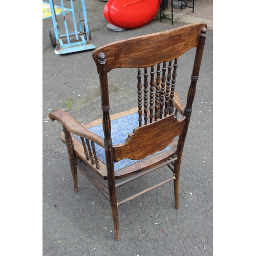 187 - An antique carved oak armchair with upholstered seat.