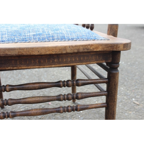 187 - An antique carved oak armchair with upholstered seat.