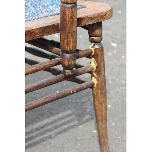 187 - An antique carved oak armchair with upholstered seat.