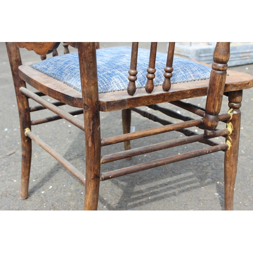 187 - An antique carved oak armchair with upholstered seat.