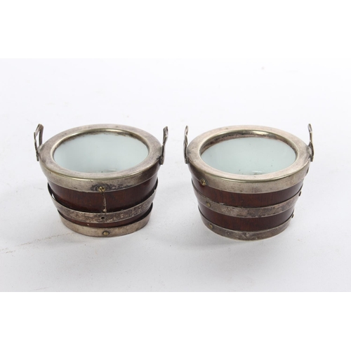 199 - A pair of antique oak salt pots in the style of barrels with ceramic liners.