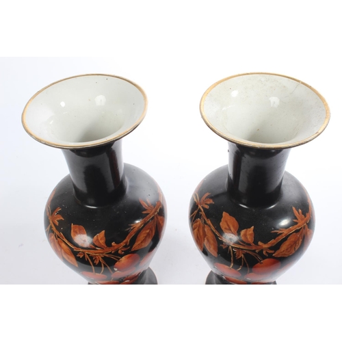 204 - A pair of hand painted vases.