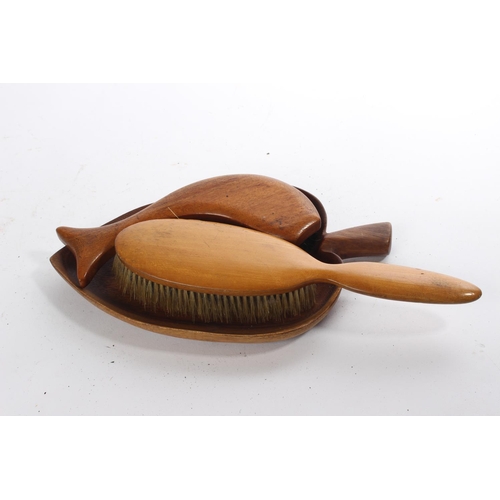 235 - Two vintage clothes brushes and a wooden leaf dish.