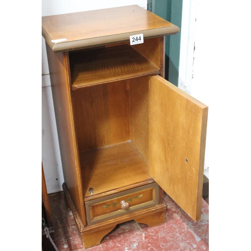 244 - A bedside cabinet with decorative design.