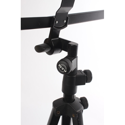 247 - A folding music stand on a tripod base.