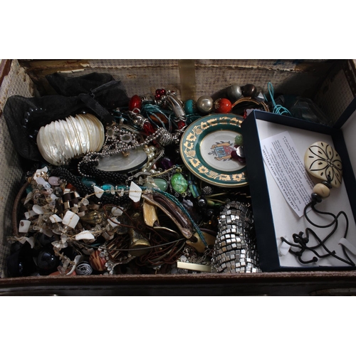 261 - A small vintage leather suitcase and a lot of assorted costume jewellery and more.