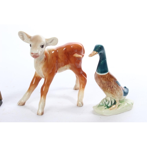 288 - 3 pieces of Beswick, to include a kid goat (a/f), another of a calf and duck and a wooden figure.