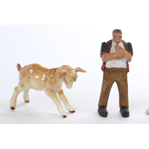 288 - 3 pieces of Beswick, to include a kid goat (a/f), another of a calf and duck and a wooden figure.