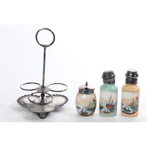 289 - An antique condiment set on a metal stand.