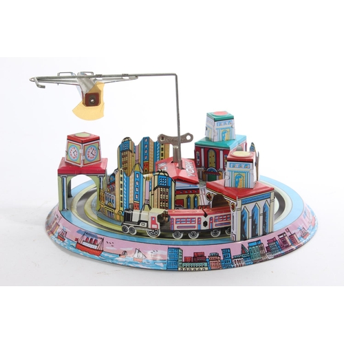 292 - A wind up tin plate toy of New York.