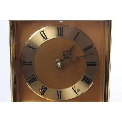 402 - A vintage Quartz mantle clock on a presentation base.