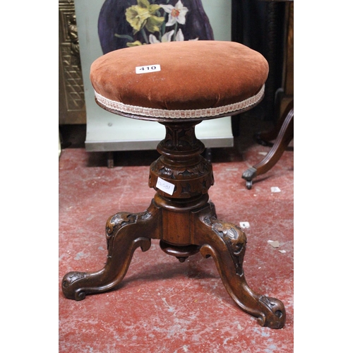 410 - An antique mahogany revolving stool with carved tripod base.