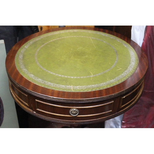 412 - A mahogany lamp table with leather top and drawer.