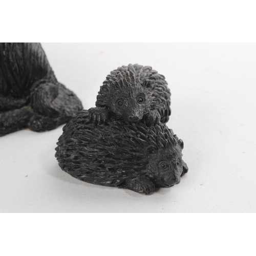 420 - Two hedgehogs and an owl made from Irish peat and another of a dog made from coal.