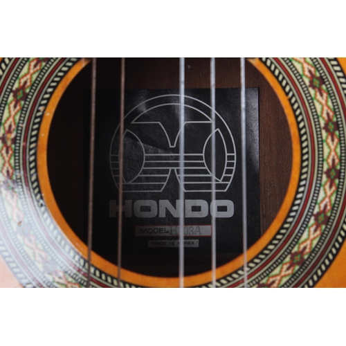 459 - A cased Hondo guitar, model H303A.