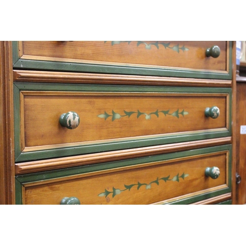 303 - A chest of five drawers with decorative design.