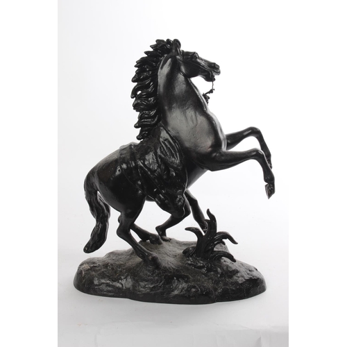 319 - An antique cast metal figure of a rearing horse.