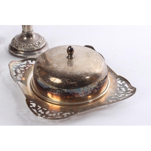 513 - A lot of silver plated and EPNS ware to include candlesticks, a butter dish and more.