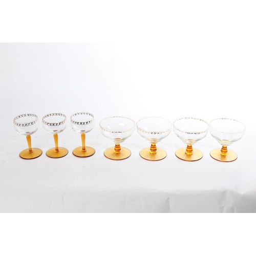 515 - A collection of vintage amber stemmed pudding bowls and glasses with gilt detail.