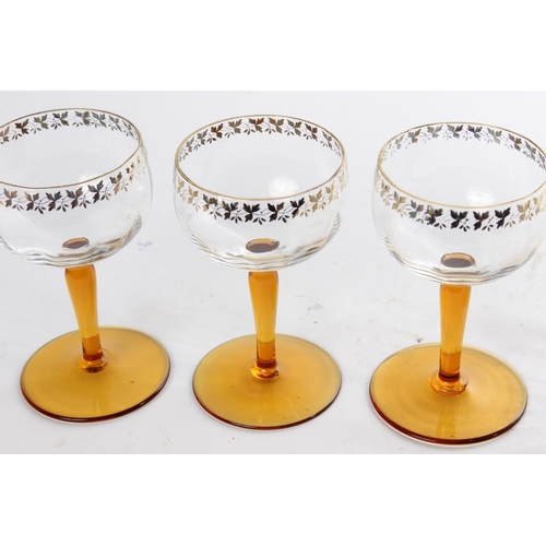 515 - A collection of vintage amber stemmed pudding bowls and glasses with gilt detail.