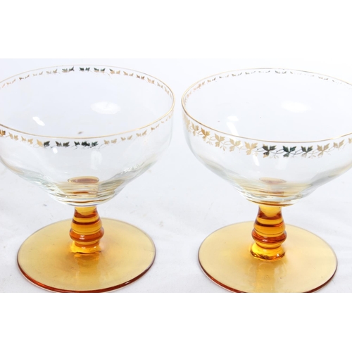 515 - A collection of vintage amber stemmed pudding bowls and glasses with gilt detail.