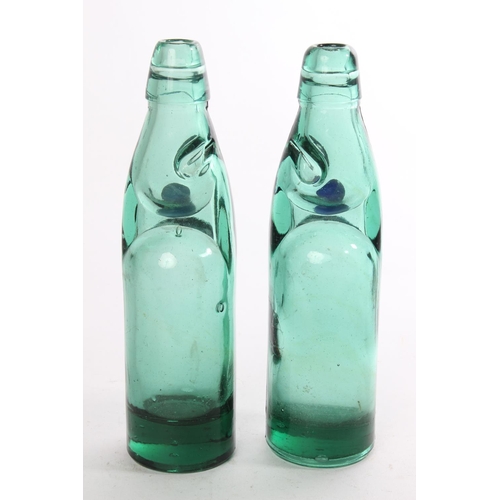 520 - Two vintage green glass bottles.