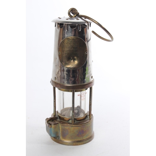 521 - An antique brass and metal miners lamp, maker 'The Protector Lamp & Lighting Company'.