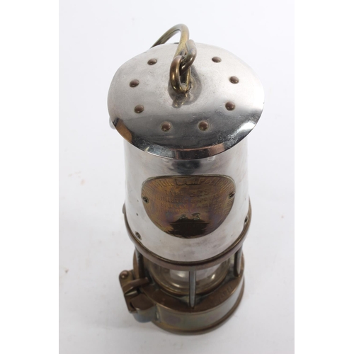 521 - An antique brass and metal miners lamp, maker 'The Protector Lamp & Lighting Company'.