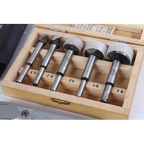 528 - A wooden cased set of five router drill bits and other tools.