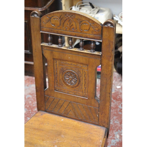 555 - An Antique mahogany hall chair.