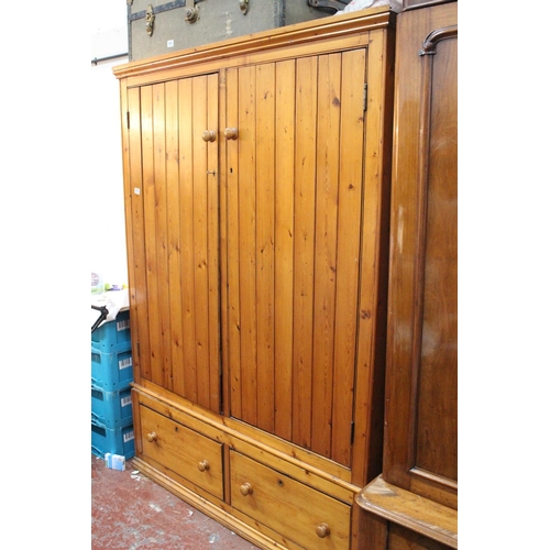 579 - A stunning large pine two door wardrobe and drawer base.