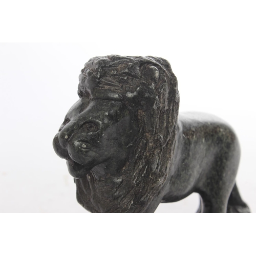 601 - A hand carving of a lion made from granite.