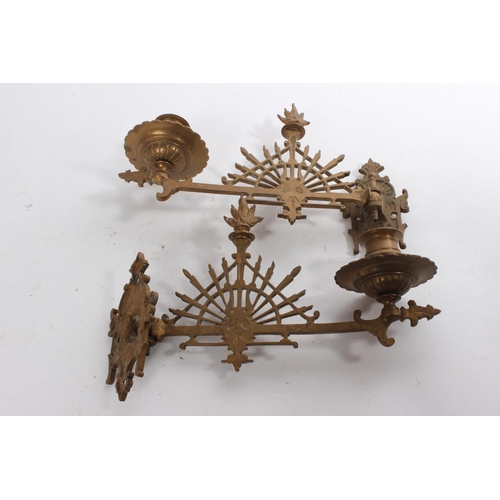 607 - A pair of antique brass piano sconces.