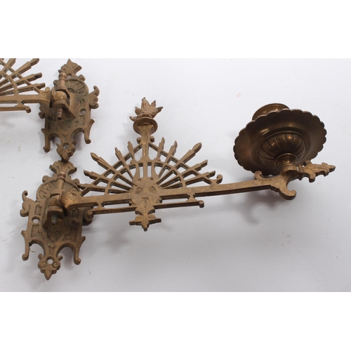 607 - A pair of antique brass piano sconces.