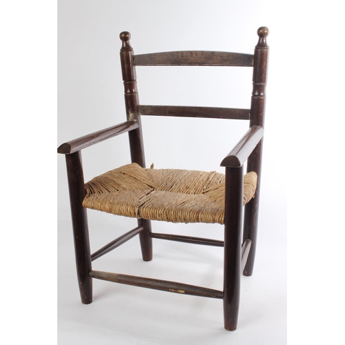 614 - A vintage child's chair with rattan seat.